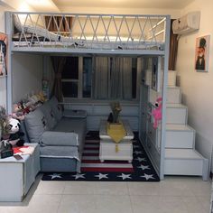 a living room with stairs leading up to the top floor and an open loft bed