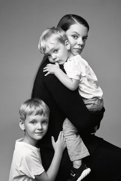 three children are posing for a black and white photo with their arms around each other