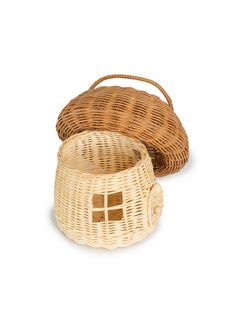 two wicker baskets sitting next to each other on a white surface, one is empty and the other has a basket in it