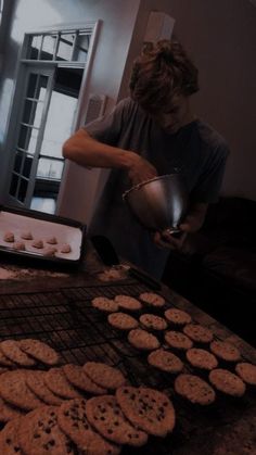 a woman cooking cookies on top of a grill