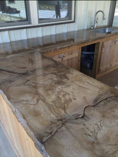 a kitchen counter top that is made out of wood and has a sink in it