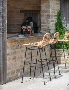 two bar stools sitting next to each other on a patio