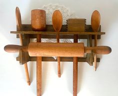 wooden utensils and spoons are arranged on a shelf