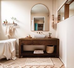 a bathroom with a sink, mirror and bathtub