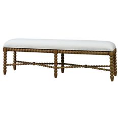 a wooden bench with a white cushion on it