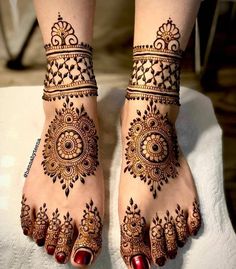 the feet are decorated with henna designs