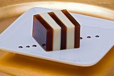 two pieces of chocolate sitting on top of a white plate