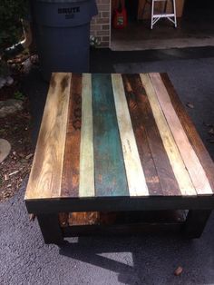 a coffee table made out of old pallet wood and painted with different colors on the top