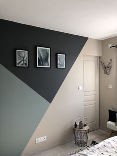 a bedroom painted in shades of purple, grey and white with pictures on the wall