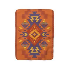 an orange and blue blanket with geometric designs