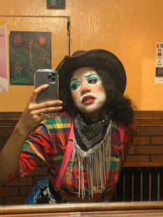 a woman in clown makeup taking a selfie