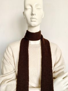 a mannequin wearing a brown knitted scarf