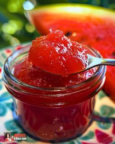 a spoon full of jam sitting on top of a plate next to watermelon slices