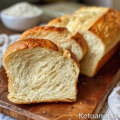 a loaf of bread sitting on top of a wooden cutting board