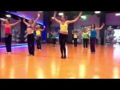 a group of women dancing on top of a wooden floor