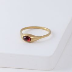 Description Hand-carved 14K yellow gold ring with a natural red garnet. Yui Ring embraces a graceful smoothness. She was made exactly for the Golden Hours - she’s confident, intelligent, poise and just entirely marvelous on her own. Not too loud, it shines just the right amount. Inspired by the nature, occasionally sweet pieces are often in organic shapes. The garnet gives a one-of-a-kind vivid red color to each ring. Details 14k Yellow GoldRed garnet - Approximately 2 x 3mm Made in U.S. *Please Red And Gold Ring, French Style Outfits, Handmade Gold Ring, Classic French Style, Too Loud, Nice Jewelry, Ring Stack, Garnet Jewelry, Garnet Ring