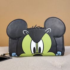 Sport Your Love For Halloween And Mickey Mouse With This Sweet Frankenstein Wallet! Best Part Of All Is It Glows In The Dark! Make This The Perfect Gift For That Special Someone... Or Just Treat Yourself! * * * * Features * * * * * Height 4" With Ears 6" * Width 1" * Length 8" With Ears 9" * Zip Closure * Gold Hardware * Faux Leather Exterior * Glow In The Dark Accents * Interior Is Black Faux Leather With Candy Mickey Print Fabric * Inside Has 1 Id Slot 7 Card Folds 3 Money Folds 1 Zip Pocket * Frankenstein Cosplay, Sequin Cards, Disney Wallet, Loungefly Hello Kitty, Goofy Movie, Card Folds, Loungefly Bag, Loungefly Disney, Disney Lilo