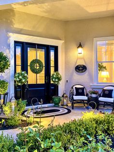 a front porch with chairs and potted plants