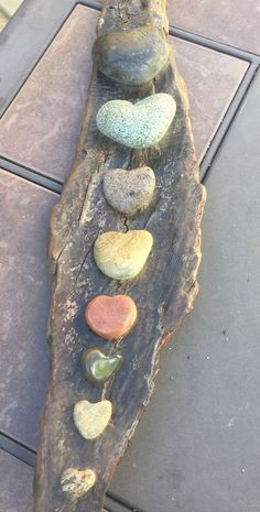 a piece of wood with rocks arranged on it