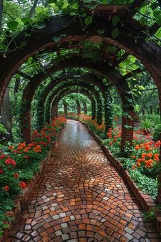 a brick pathway surrounded by flowers and greenery