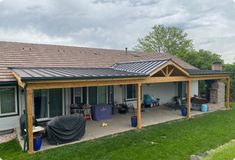 a house with a covered patio in the yard