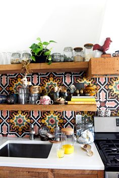 the kitchen counter is covered with pots and pans on it, along with other items