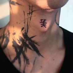 a woman with a tattoo on her neck that has chinese characters painted on it's chest