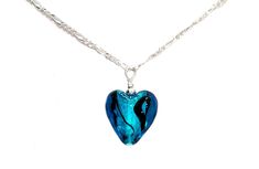 "~ Contemporary Murano Glass Lampwork Small Heart Pendant Necklace ~ Pendant is 5/8\" wide  x 3/4\" height (height includes bead and wire loop), puffed to a depth of 1/4\" ~ Semi-translucent aqua blue foil core shimmer with black ribbon swirls   ~ Pendant is uniquely created, no two exactly alike!  Yours will look very similar to the one pictured with slight variations. ~ .529 Sterling Silver bead and loop for pendant  ~ .529 Sterling Silver Figaro Chain with Lobster Clasp ~ Arrives in a white s Blue Heart Necklaces For Party, Blue Glass Heart Beads Jewelry, Blue Glass Jewelry With Heart Beads, Blue Necklace With Heart Charm, Blue Necklace With Round Heart Charm, Blue Necklaces With Heart Charm And Round Shape, Nickel-free Blue Heart Necklaces, Blue Adjustable Necklace For Valentine's Day, Adjustable Blue Necklace For Valentine's Day