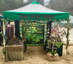 a green tent with plants and trees on it