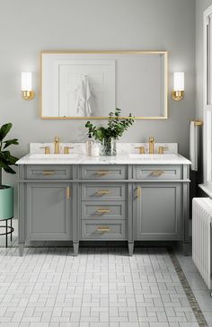 a bathroom with two sinks and mirrors on the wall next to a plant in a vase