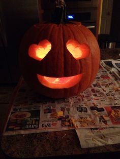 a pumpkin with hearts carved into it