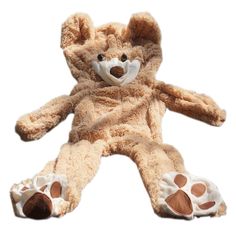 a brown teddy bear laying on its side with paws spread out and eyes wide open