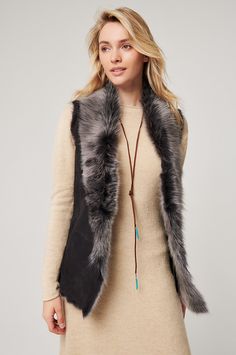 Add warmth and style to any outfit with this uniquely colored Toscana sheepskin vest. The color of an early morning winter sky or a shadow-dappled winterscape, this raw-edge style flatters with a softly draped, collarless open-front design and subtly shaped seams. Two lined slip pockets and an inner zip pocket add wear-everywhere functionality. Pair with a midi skirt and boots for a romantic look, or over city attire for upscale style—either way, you'll be gorgeous and cozy warm. Black Fur Vest Outfit Ideas, Fur Vest Outfit Ideas, Black Fur Vest Outfit, Fur Vest Outfit, Vest Outfit Ideas, Fur Vest Outfits, Midi Skirt And Boots, Sheepskin Vest, Morning Winter