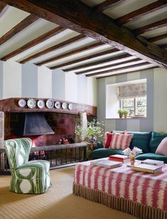 a living room filled with furniture and a fire place in the middle of a room