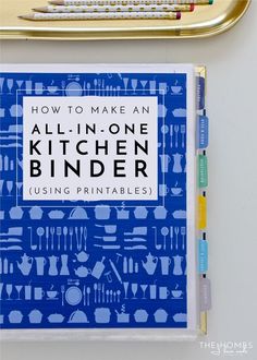 an all - in - one kitchen binder sits next to a pen and ruler