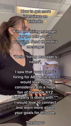 a woman sitting at a desk with a cake in front of her