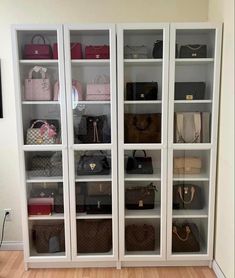 a large white bookcase filled with lots of purses