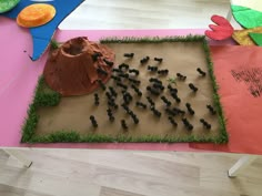 there is a cake made to look like an area with grass and rocks