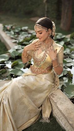 a woman sitting on top of a lush green field