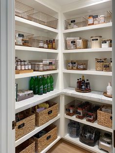 an organized pantry with lots of bottles and baskets