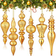 golden christmas ornaments hanging from a tree