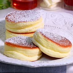 three powdered sugar filled pastries on a white plate