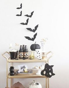 a shelf with halloween decorations and bats on it