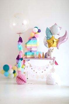 a table topped with balloons and other items