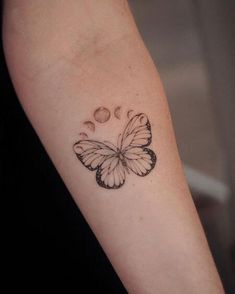 a small butterfly tattoo on the arm