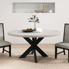 a table with two chairs and a vase on it in a room that has carpeted flooring