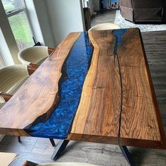 the table is made out of wood and has blue paint on it's edge