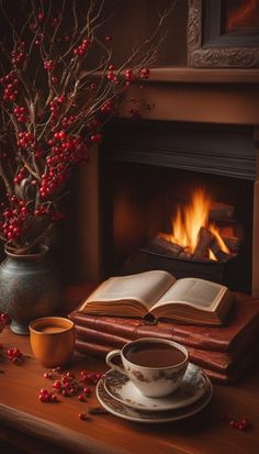 an open book and cup of coffee on a table next to a fireplace with red berries