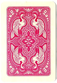 a red and white playing card with two birds on the front, in an ornate design