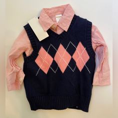 New With Tag. Gymboree Argyle Sweater Vest With Button Down Shirt. Vest Is Navy Blue With Pink Designs And The Shirt Is Pink. Size 12-18 Months. Flawless! This Item Is Kept In A Smoke And Pet Free Environment. Pink Cotton Sweater, Pink Tops For Playtime In Fall, Pink Tops For Playtime During Fall, Pink Cotton Sweater For Playtime, Pink Argyle Sweater Vest, Blue Button-up Vest With Button Closure, Sweater Vest Argyle, Vintage Gymboree Clothes, Argyle Sweater Vest